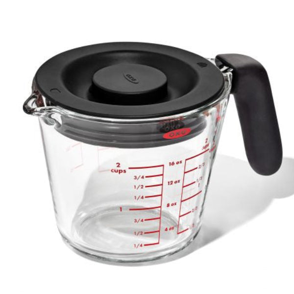 500 ml glass measuring cup with a secure lid and easy-to-read markings for precise, mess-free measuring.